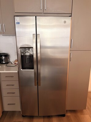 A stainless steel refrigerator with a water dispenser, a built-in ice maker, and a freezer compartment. - 2-bedroom apartment in soothing Grand Prairie with AC and fitness room (Grand Prairie)