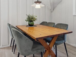 A dining table with six chairs, a vase with greenery, and a hanging light fixture. - "Tenna" - 30km from the sea by Interhome (Toftlund)