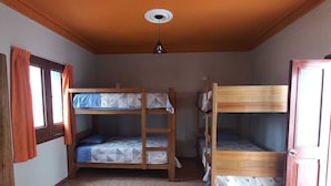 A room with bunk beds, a window with curtains, a ceiling fan, and a tiled floor. - ILLA HOSTELS (Arequipa)