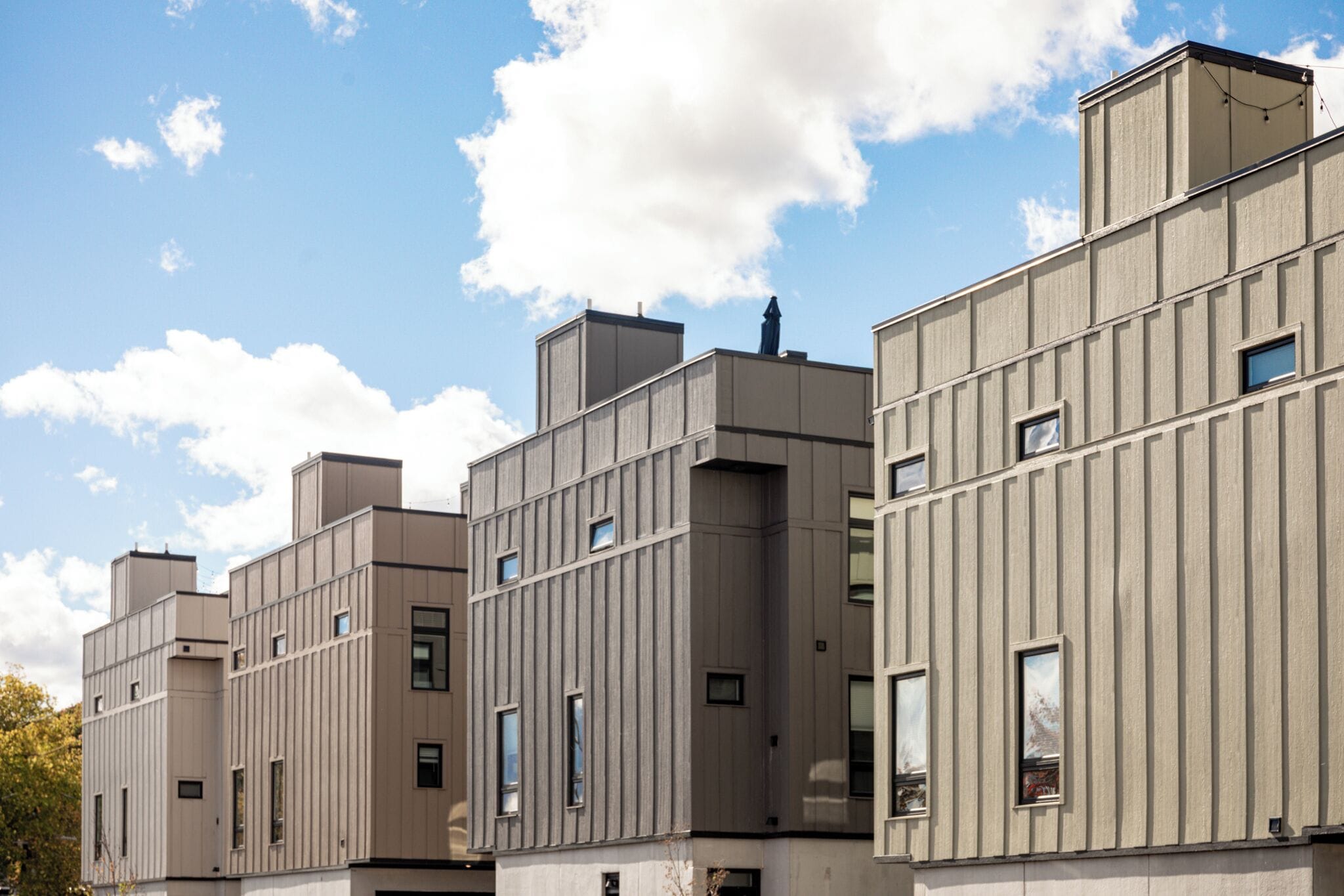 A modern building with multiple floors and a flat roof.