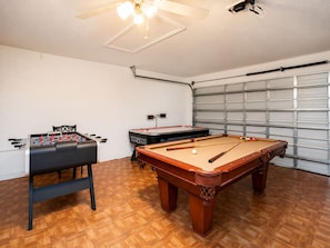 A room with a foosball table, a pool table, and a ceiling fan. - Luxury 5BR Orlando Villa | Private Pool & Spa | Games Room | Near Disney (Davenport)