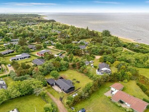 A residential area with houses surrounded by greenery and a body of water in the background. - "Jonnhild" - 100m to the fjord by Interhome (Tarm)
