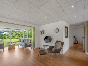 A modern living room with a sofa, armchair, and a round table. - "Jonnhild" - 100m to the fjord by Interhome (Tarm)