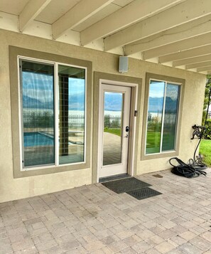 A building with large windows, a door, and a covered entrance area.