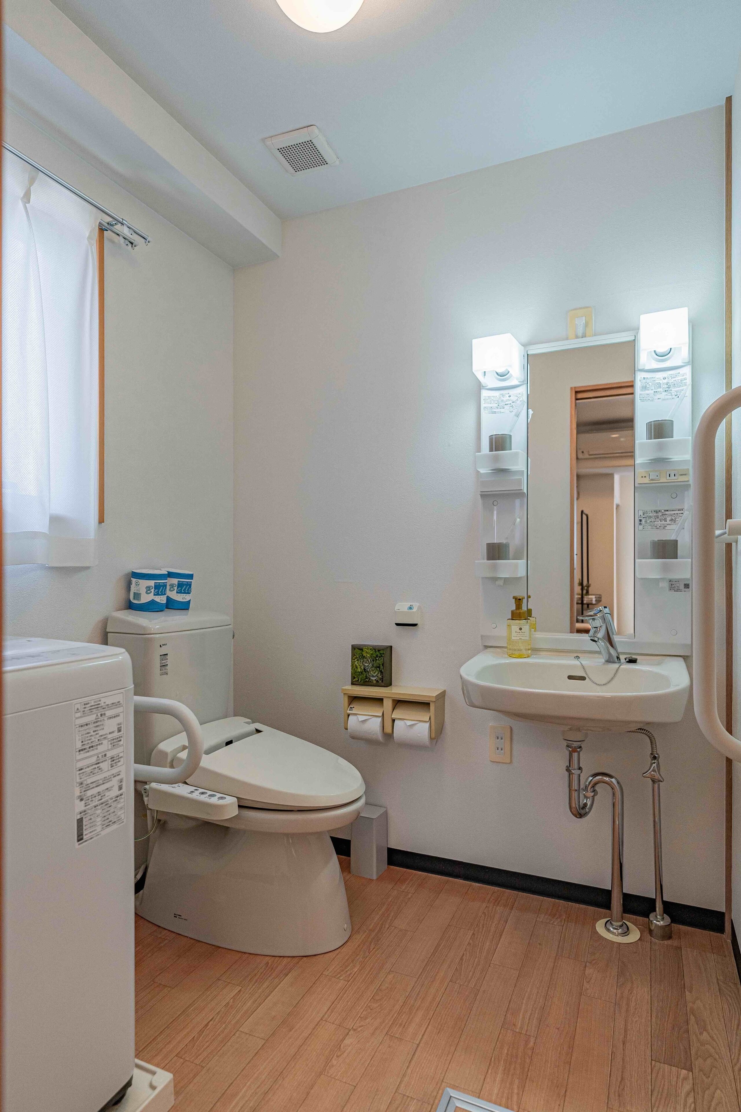 A modern bathroom with a toilet, sink, and shower.