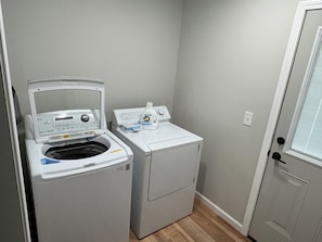 A laundry area with a front-loading washing machine and a dryer.