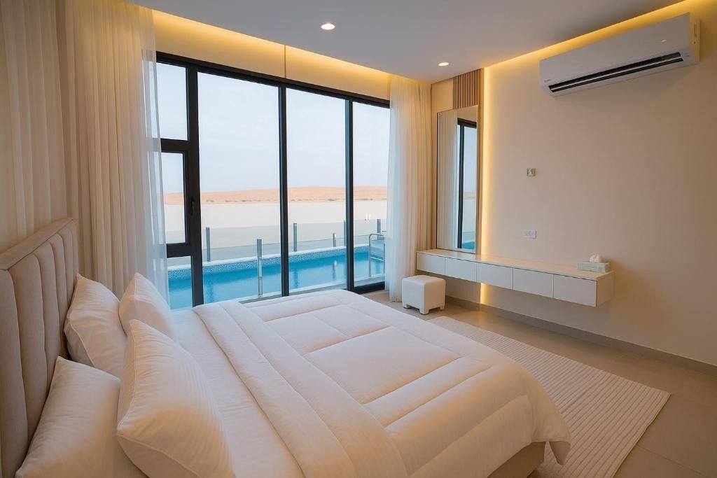 Quarto moderno com uma cama grande, vista para o mar e ar condicionado.