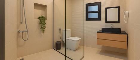 A modern bathroom with a glass partition, a shower, a toilet, a sink, and a mirror.