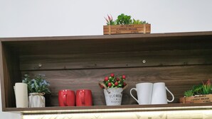 A kitchen with a stainless steel sink, a wooden shelf above it, and a patterned backsplash. - Localview Balcony-Trainstreet -Netflix-King Bed-Guide book (Hà Nội)