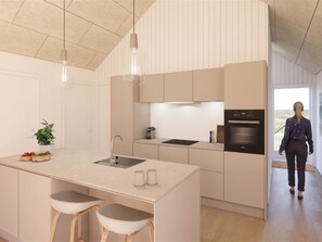 A modern kitchen with a central island, bar stools, a built-in oven, and pendant lighting. - "Thormund" - 400m from the sea by Interhome (Ringkøbing)