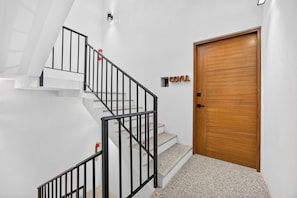 A staircase with black railings and a wooden door with a 'COYUL' sign. - Family-Friendly Apartment in Puerto Vallarta (Puerto Vallarta)