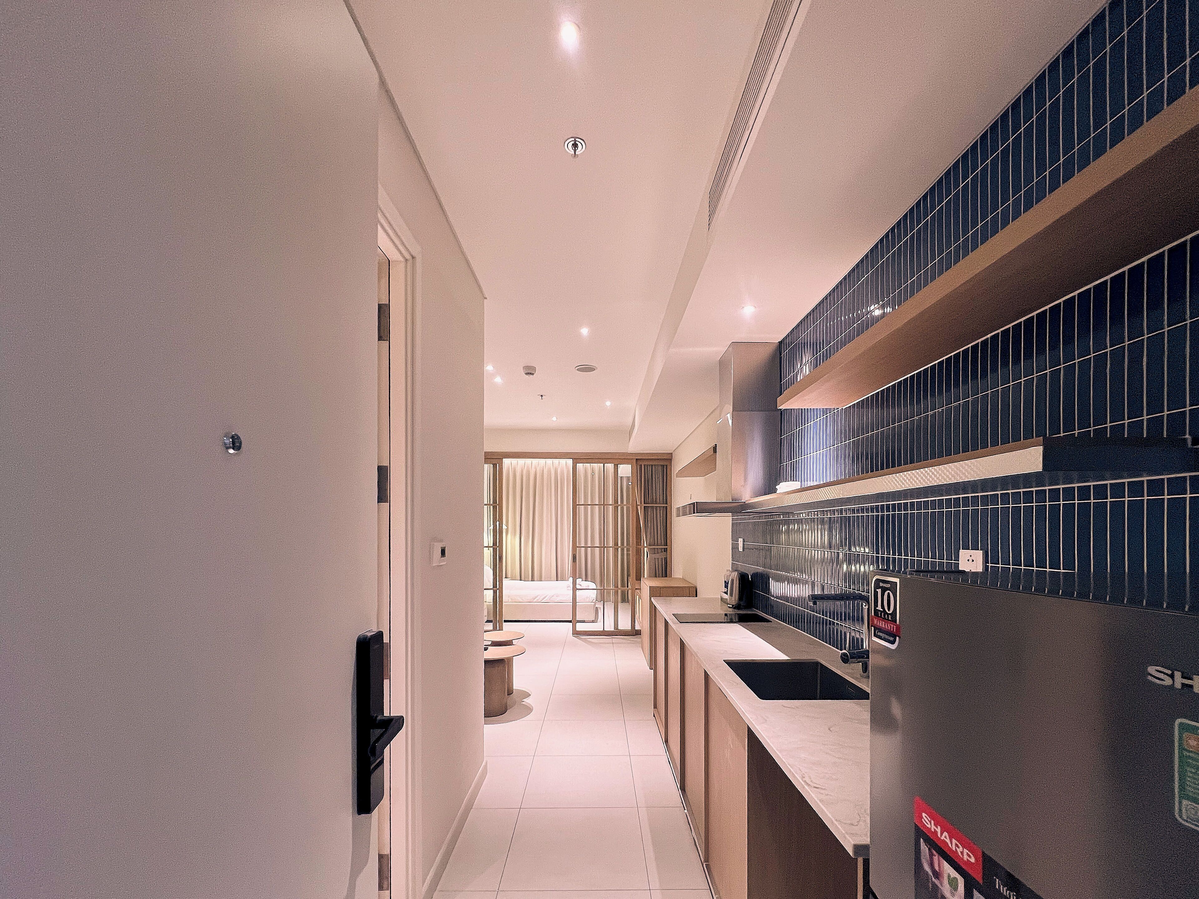A modern kitchen with a countertop, a sink, and a tiled backsplash.