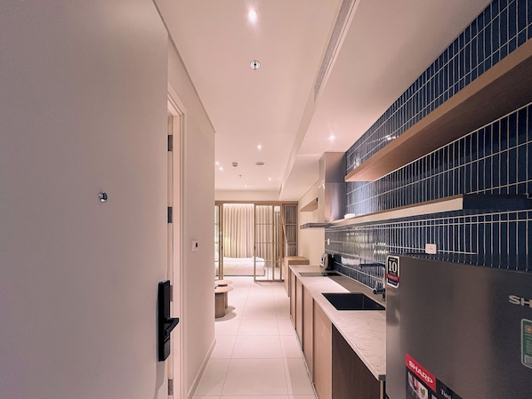 A modern kitchen with a countertop, a sink, and a tiled backsplash.