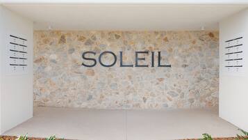 A stone wall with the word 'SOLEIL' in large letters.