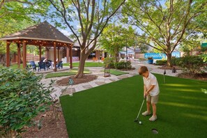 A golf course with a pavilion, a putting green, and a well-maintained lawn. - Epic TX Stay: Pickleball•Golf Sim•Theater•Sleeps24 (Spring)