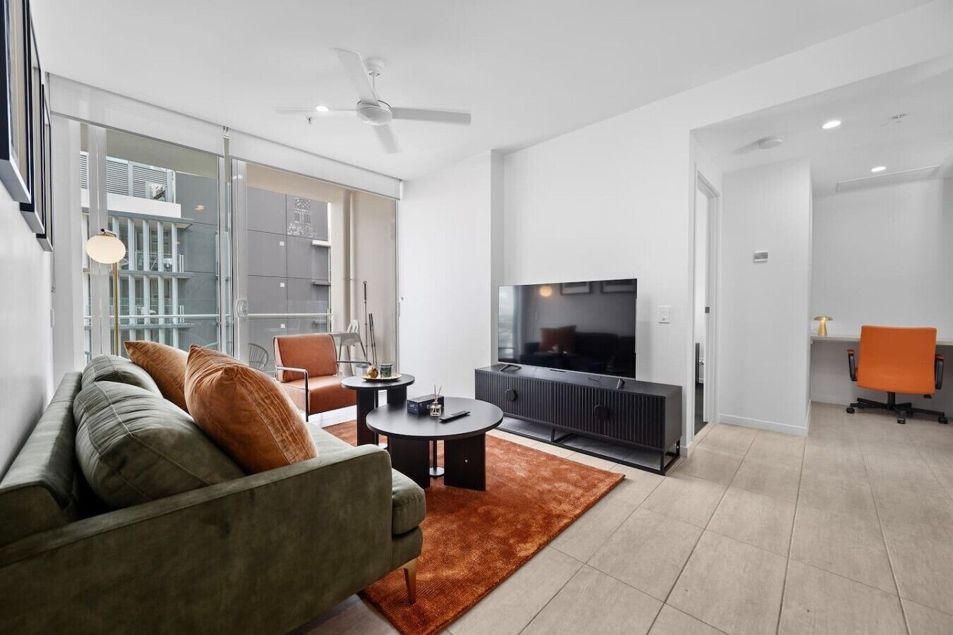 A modern living room with a sofa, coffee table, and TV.