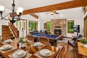A spacious living area with a pool table, fireplace, and comfortable seating. - Harmony Pines | Hot Tub & Beach Access (Lake Harmony)
