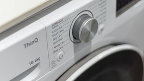 A front view of a washing machine with a control panel and a label indicating 'ThinQ' and '10/6kg'. - Great Value|Renovated Studio|Prime Location|Aircon (Nathan)
