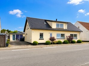 A two-story residential house with a sloped roof, a front porch, and a driveway. - "Edin" - 4km from the sea by Interhome (Løkken)