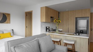 A modern kitchen with wooden cabinets, a built-in oven, and a stainless steel refrigerator. - Reforma Elegance · A Pasos del Monumento & Ángel (Ciudad de México)