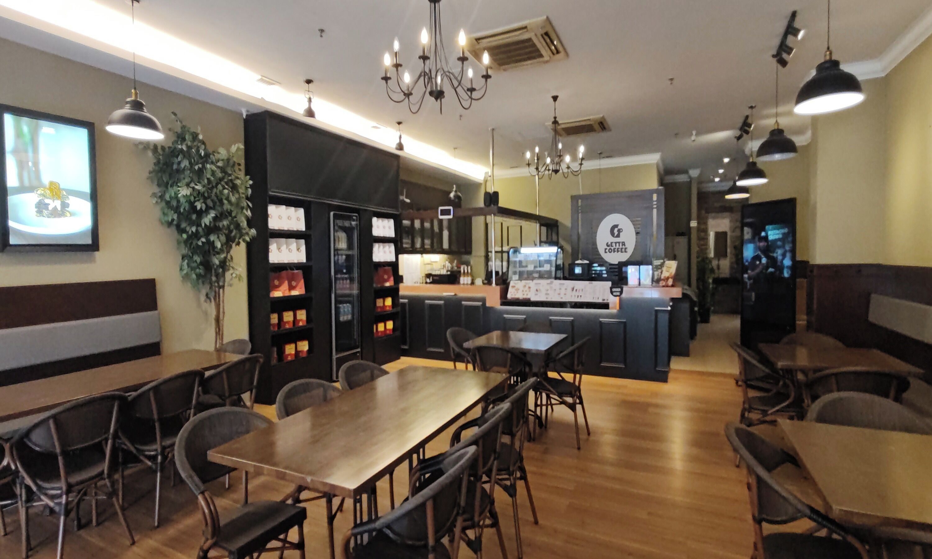 A restaurant with a bar area, seating arrangements, and a coffee station.