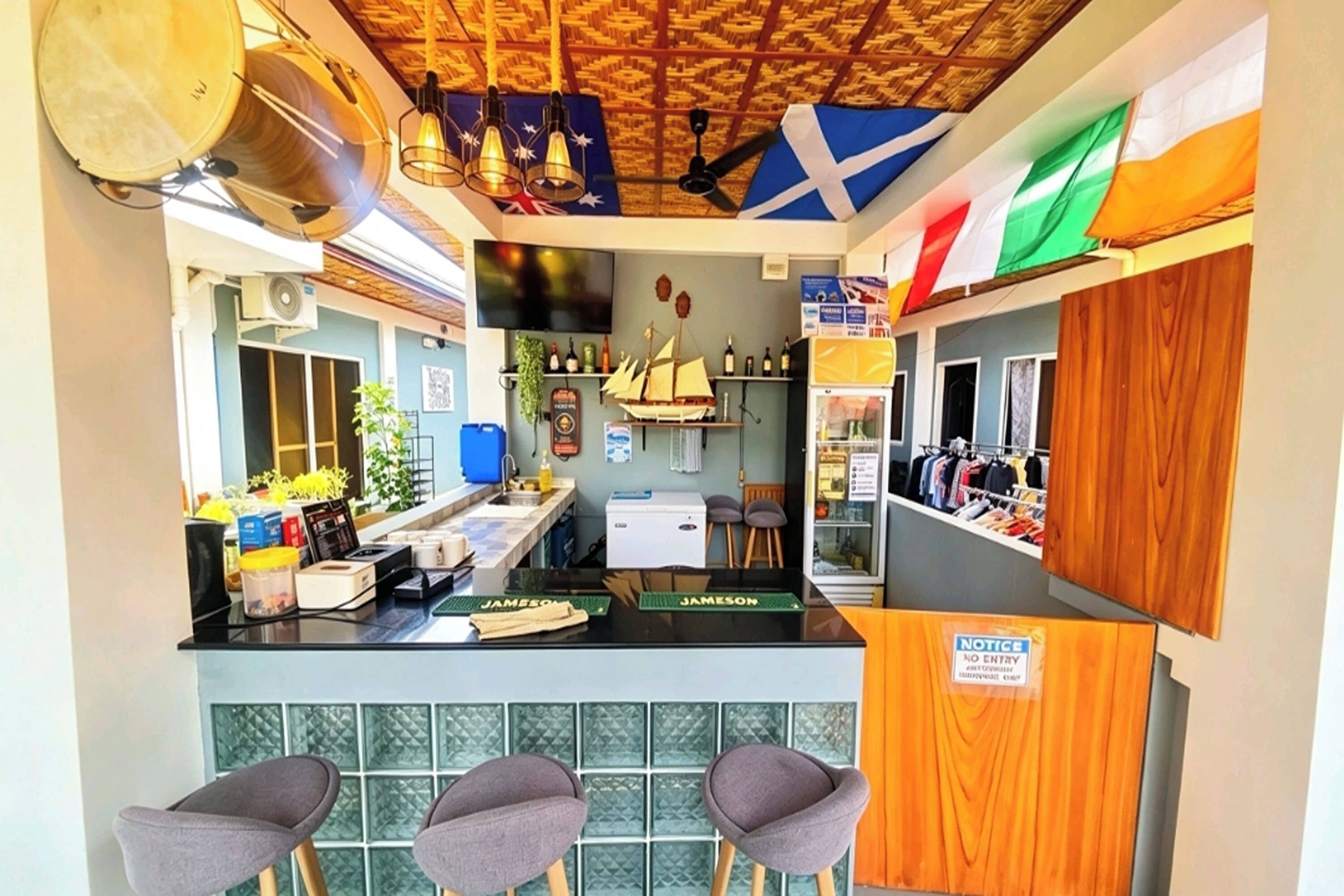 A bar area with stools, a counter, and a sign indicating no entry.