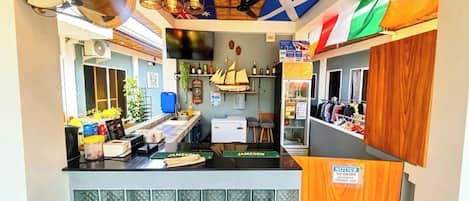 A bar area with stools, a counter, and a sign indicating no entry.