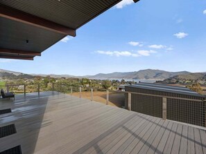 A deck with a view of a mountainous landscape and a body of water. - Ridge Way Views - Breathtaking Lake Eildon Views (Mountain Bay)