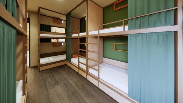 A bunk bed room with a ceiling fan, wooden bunk beds, and green curtains. - Rebel Rooster Hostel (Hanoi)