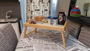 A small kitchenette with a wooden table, a box of Zaxaph, and a coffee maker. - Coastal Haven οf Piraeus - by ΜΡS (Pireas)