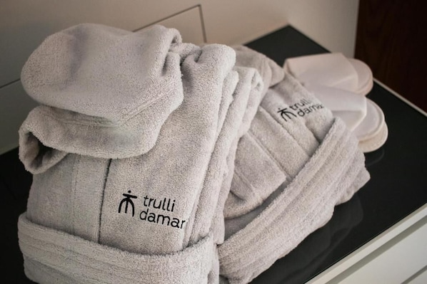 A stack of white towels with a logo and text on them.