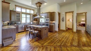A spacious kitchen with a central island, stainless steel appliances, and a large window providing natural light. - Stunning Eagle-Vail Escape! Mtn Views + Deck (Avon)