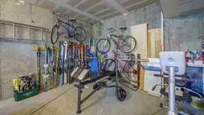 A garage with bicycles, skis, and a weight bench. - Stunning Eagle-Vail Escape! Mtn Views + Deck (Avon)
