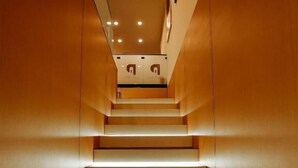 A staircase with illuminated steps leading to a landing. - Nooma Hotel on Frunze (Bishkek)