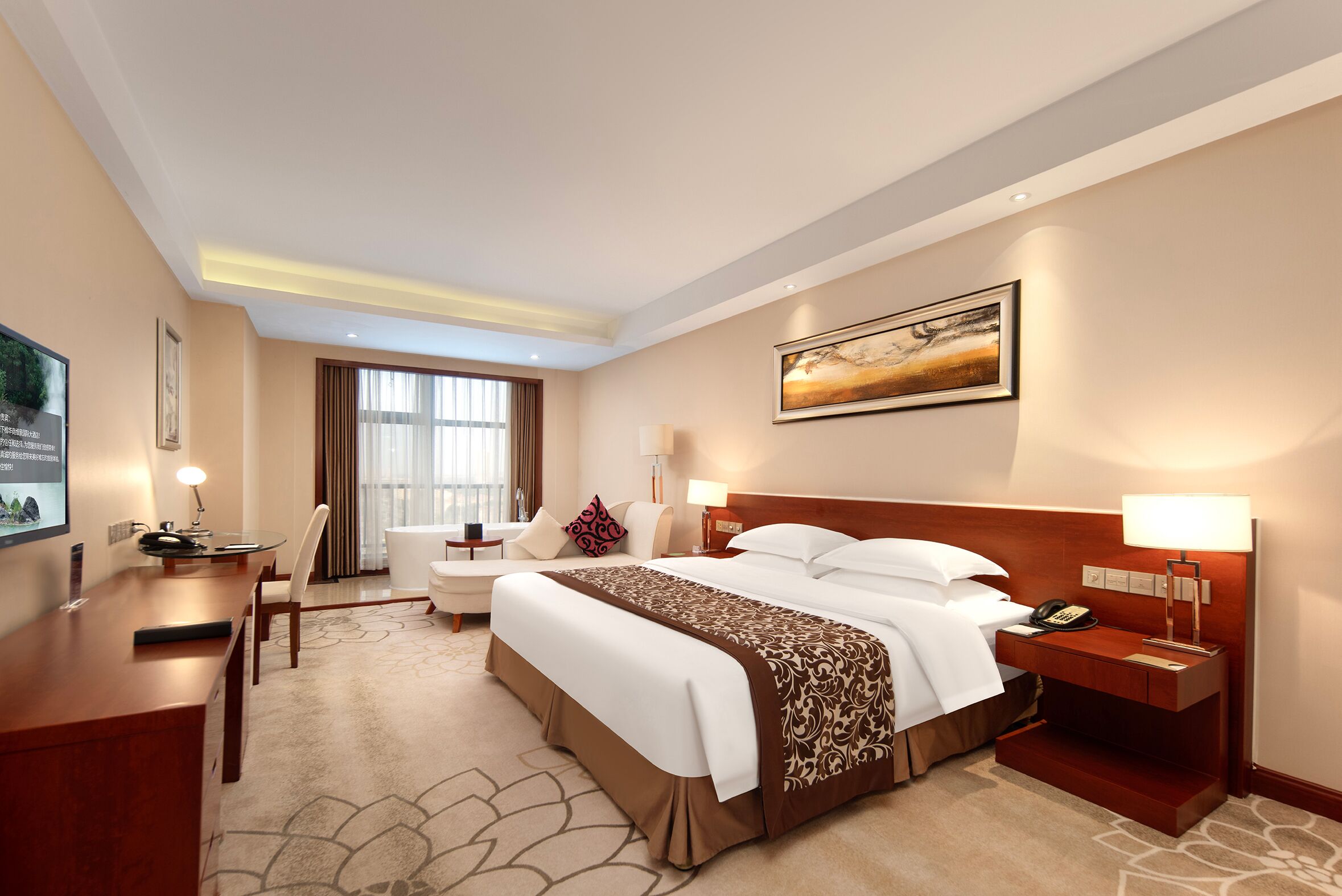 A hotel room with a large bed, a desk, a chair, a sofa, a nightstand, and a painting on the wall.