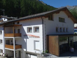 A two-story building with a balcony on the ground floor and a shop on the right. - Apart Bellezza, (Samnaun-Dorf) by Interhome (Samnaun)