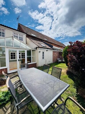 A house with a patio, a table, and chairs. - The Old Ropery at Mill Cottage  (Ollerton)