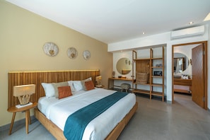 A modern bedroom with a wooden headboard, a bed with white bedding, a desk with a chair, and a wardrobe. - Villa Yuka (Ubud)