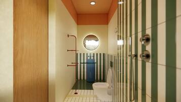 A narrow bathroom with a toilet, a sink, and a mirror.