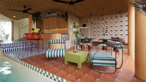 A poolside area with striped chairs, a small table, and a bar area with bottles. - Hatha House (Tabanan)