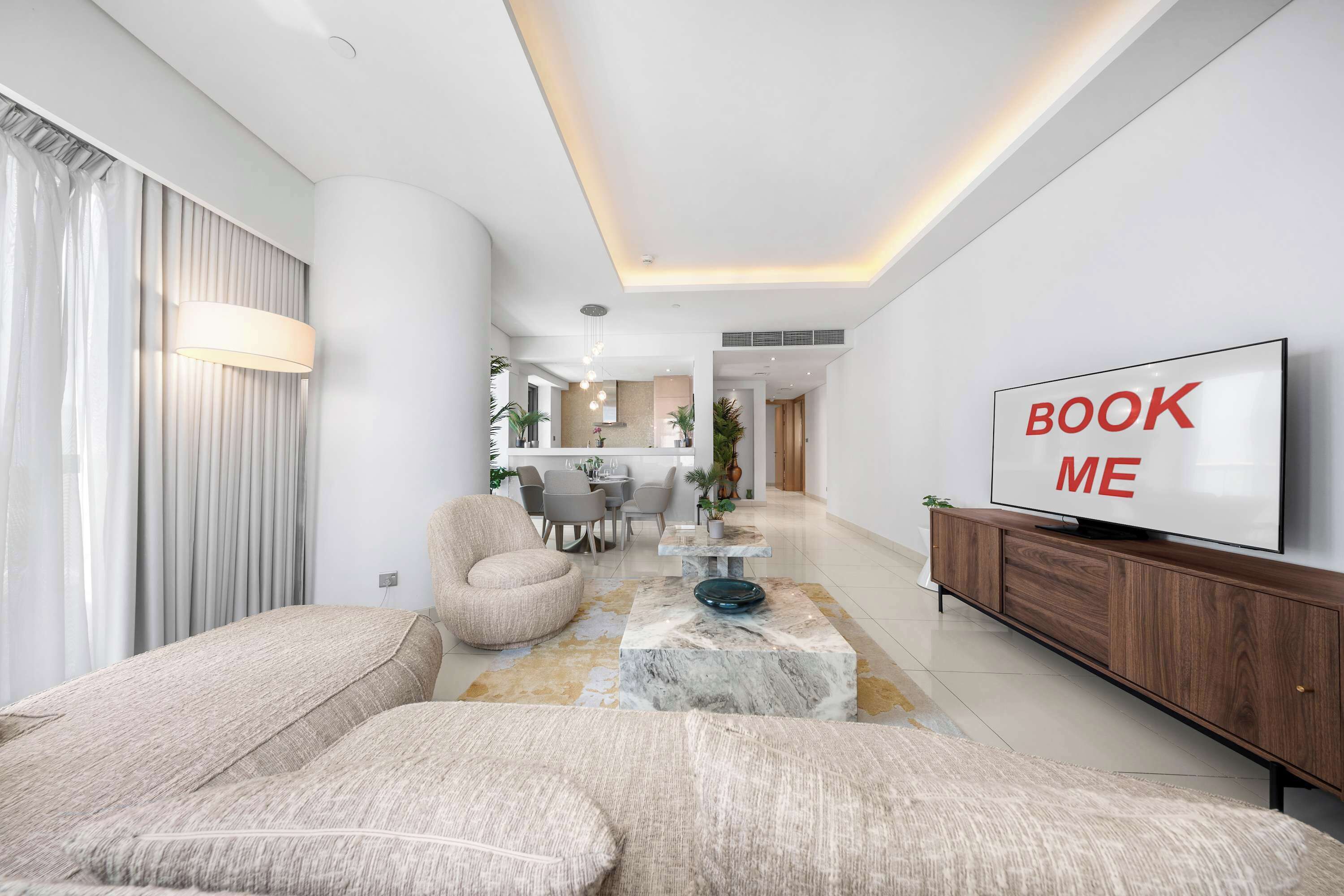 A modern living room with a sofa set, a coffee table, and a television on a wooden cabinet.