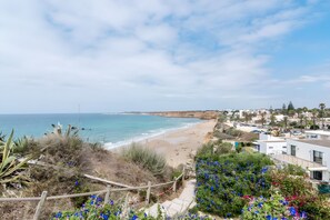 A coastal view with a beach, a clear sky, and a residential area with buildings. - Tomy Apartment – Families Only, Sea View, Balcony, Wi-Fi (Conil de la Frontera)