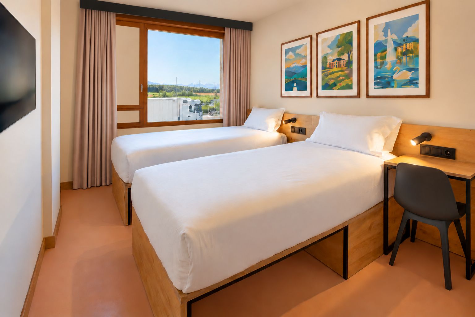 A hotel room with two beds, a desk, and a chair. There are three framed paintings on the wall.