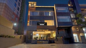 A modern building with a sign reading 'TOURNHOUSE Company Serviced'. - Townhouse Sector 20 Panchkula (Dera Bassi)