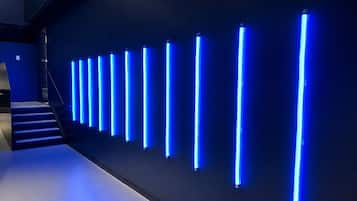 A modern interior with a series of vertical light fixtures on a wall.