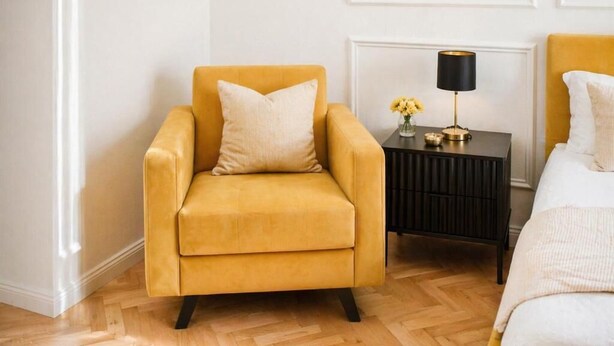 A room with a yellow armchair, a bedside table with a lamp, and a bed with white bedding. - Modern Elegance & Old-World Charm in the Most Iconic District – 623 (Budapest)