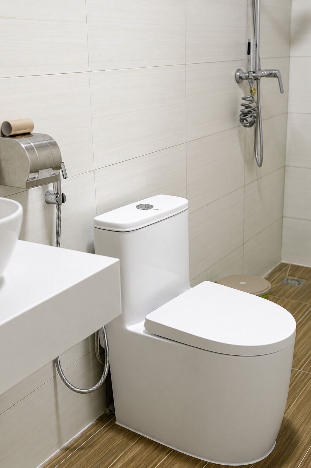 A modern bathroom with a toilet, bidet, and a shower.