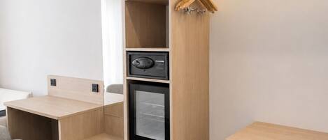 A modern, well-organized room with a desk, a built-in wardrobe, and a coat rack.