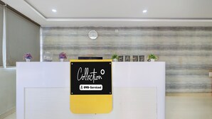 A reception desk with a sign that reads 'Collection' and 'OYO-Serviced'. - Collection O Atchutapuram (Visakhapatnam)