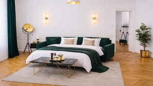 A hotel room with a bed, bedside table, lamp, and a potted plant. - Luxury Riverside Hideaway w/ Panoramic Views & Top Amenities – 622 (Budapest)